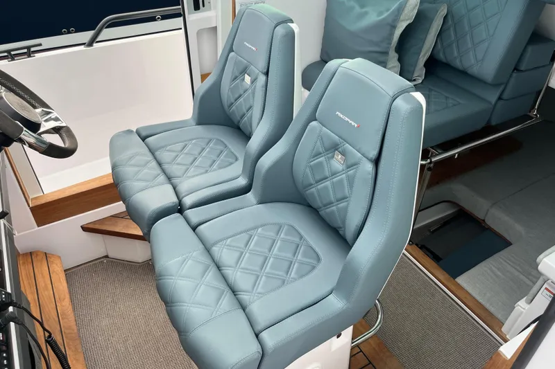 Slide: The Image of 2022 Axopar 28 Cabin Brabus Package interior with luxurious blue leather seats. - 16