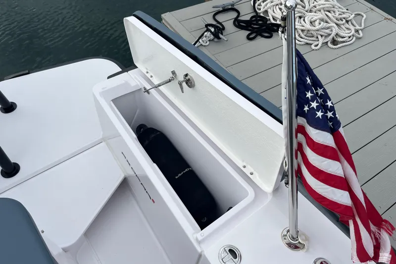 Slide: The Image of Axopar 28 Cabin 2022 boat with Brabus Package, open storage, and American flag. - 25