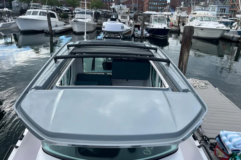 Slide: The Image of 2022 Axopar 28 Cabin with Brabus Package docked at a marina. - 33