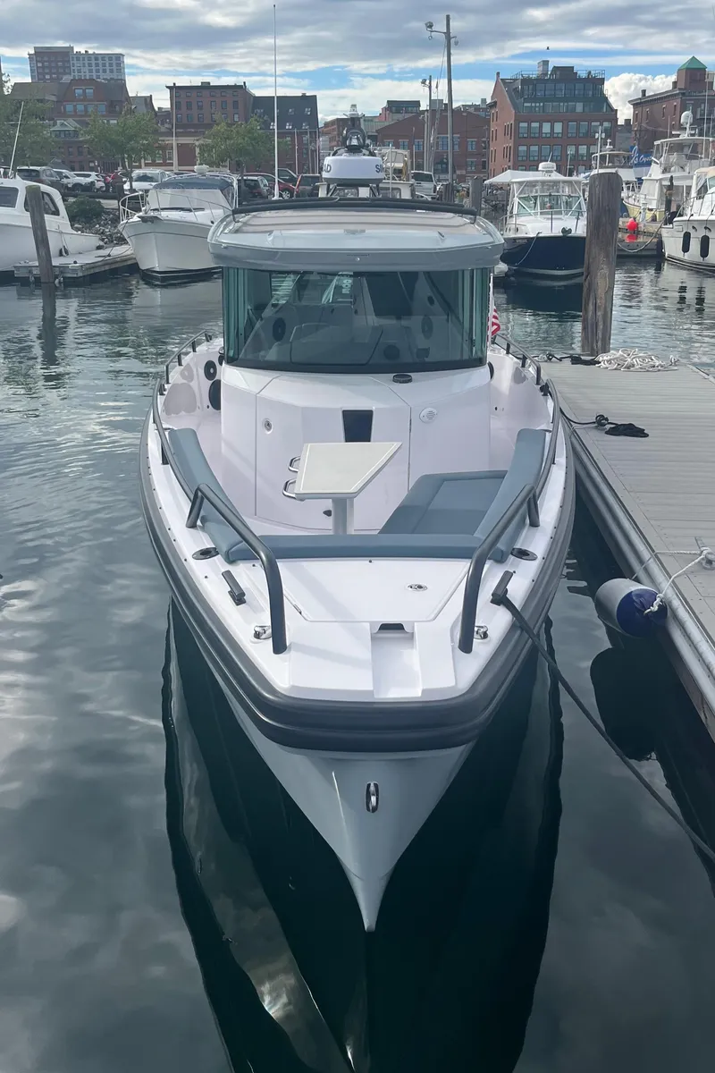 Slide: The Image of 2022 Axopar 28 Cabin with Brabus Package docked in a marina. - 38