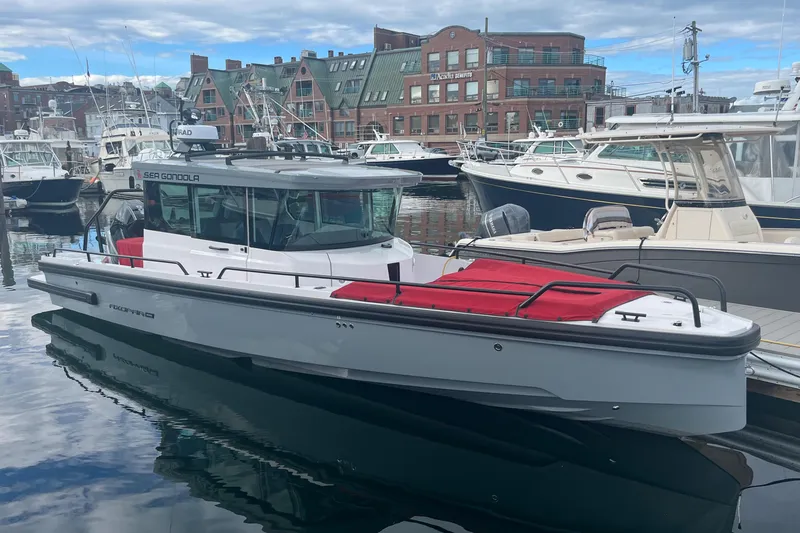 Slide: The Image of 2022 Axopar 28 Cabin with Brabus Package docked in a marina. - 39