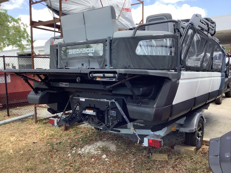Slide: The Image of 2024 Sea-Doo Switch Cruise 18 pontoon boat on trailer, rear view. - 4