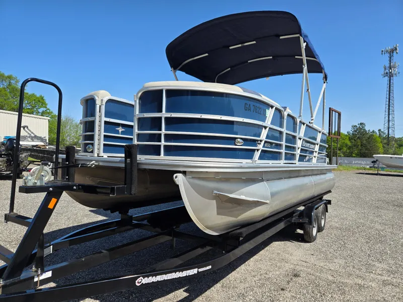 Slide: The Image of 2021 Berkshire 22 RFX LE-Series pontoon boat on trailer, blue and silver, with canopy. - 1