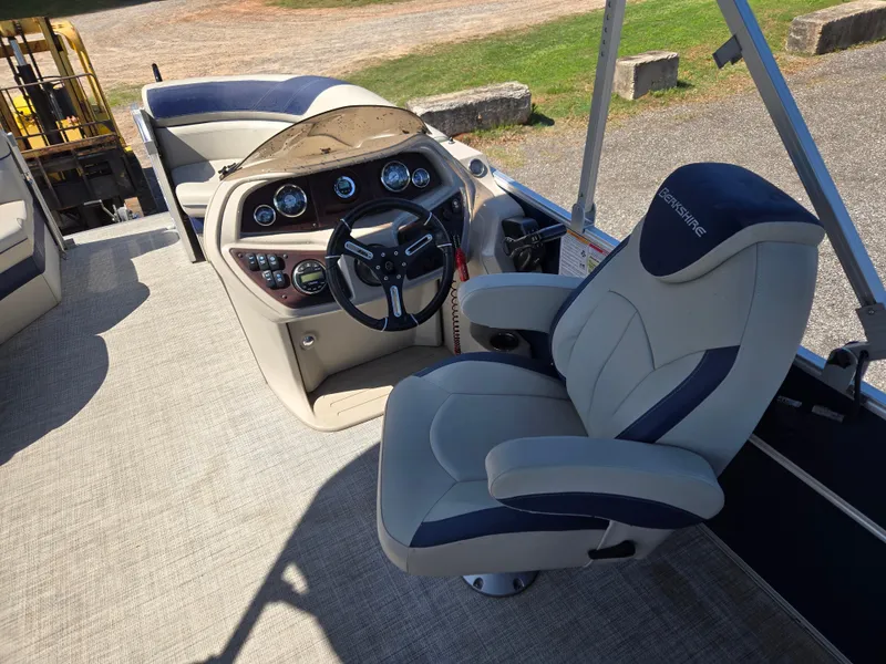 Slide: The Image of 2021 Berkshire 22 RFX LE-Series boat interior with captain's chair and control panel. - 12