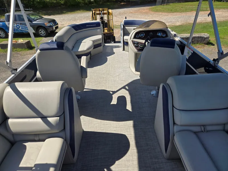 Slide: The Image of 2021 Berkshire 22 RFX LE-Series pontoon boat interior with plush seating and steering console. - 13