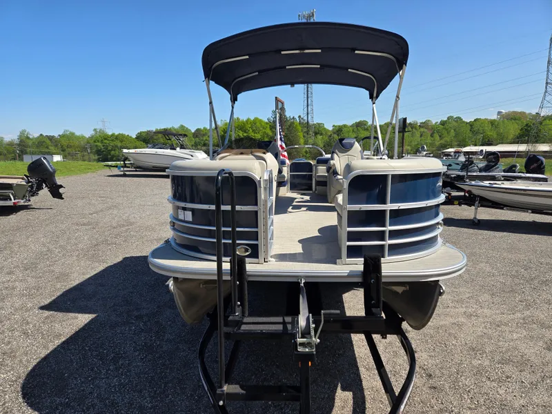 Slide: The Image of 2021 Berkshire 22 RFX LE-Series pontoon boat on trailer, parked outdoors. - 2