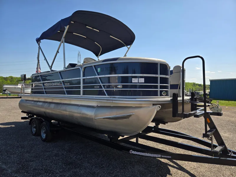 Slide: The Image of 2021 Berkshire 22 RFX LE-Series pontoon boat on trailer, with canopy, in outdoor setting. - 3