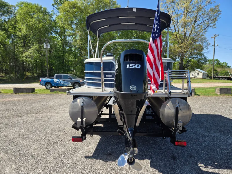Slide: The Image of 2021 Berkshire 22 RFX LE-Series pontoon boat with American flag and 150 HP engine. - 6