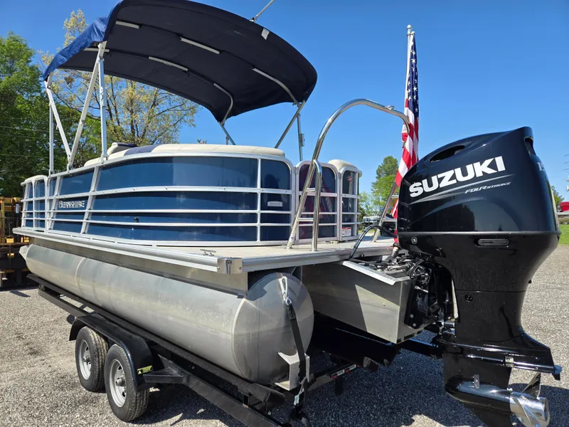 Slide: The Image of 2021 Berkshire 22 RFX LE-Series pontoon boat with Suzuki outboard motor on trailer. - 7