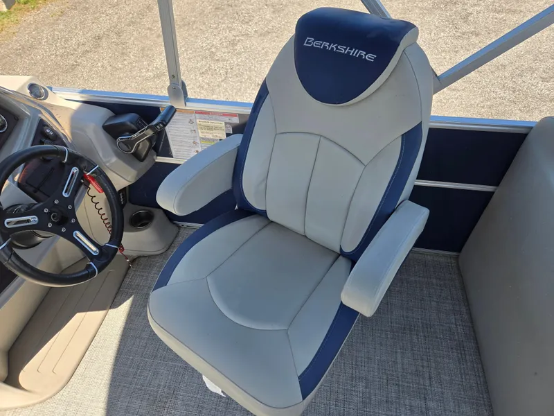 Slide: The Image of Captain's chair in 2021 Berkshire 22 RFX LE-Series boat, featuring ergonomic design and steering wheel. - 8