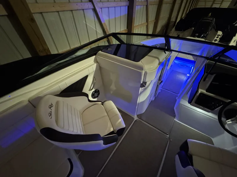 Slide: The Image of 2019 Sea Ray SPX 230 boat interior with illuminated seating and modern design. - 10
