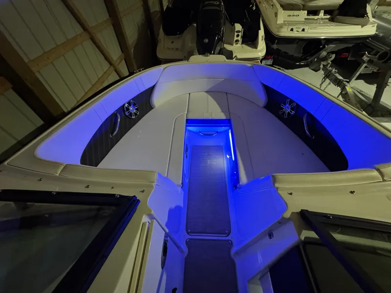 Slide: The Image of 2019 Sea Ray SPX 230 boat interior with blue LED lighting in a storage area. - 12