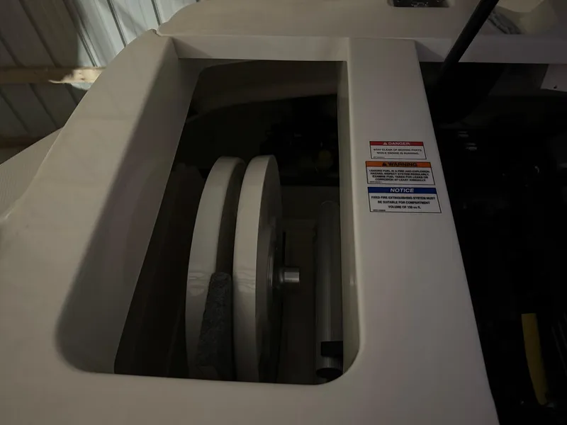 Slide: The Image of 2019 Sea Ray SPX 230 boat component with visible pulley system and safety labels. - 18