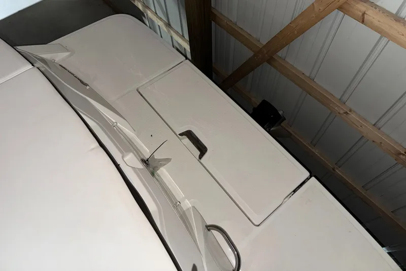 Slide: The Image of 2019 Sea Ray SPX 230 boat interior, featuring a storage compartment and seating area. - 19