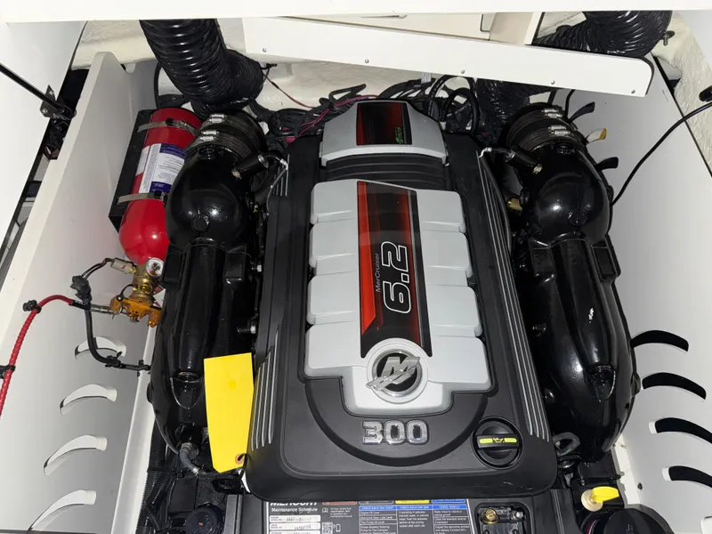 Slide: The Image of 2019 Sea Ray SPX 230 engine compartment with 6.2L 300 HP engine and fire extinguisher. - 22