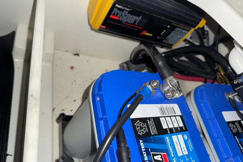 Slide: The Image of Battery compartment of a 2019 Sea Ray SPX 230 with ProSport charger. - 24