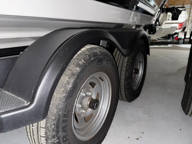Slide: The Image of Trailer wheels of a 2019 Sea Ray SPX 230 boat in a garage setting. - 26
