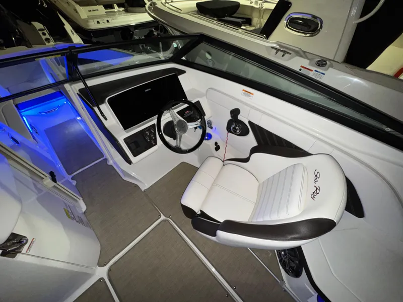 Slide: The Image of 2019 Sea Ray SPX 230 boat interior with steering wheel and seating. - 8