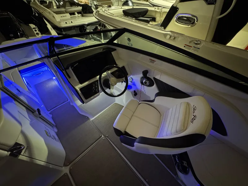 Slide: The Image of 2019 Sea Ray SPX 230 boat interior with illuminated cockpit and steering wheel. - 9