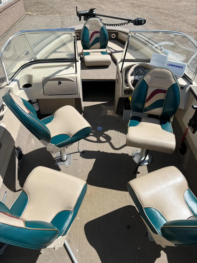 Slide: The Image of 2001 Alumacraft Trophy 185 boat interior with four seats and steering console. - 14