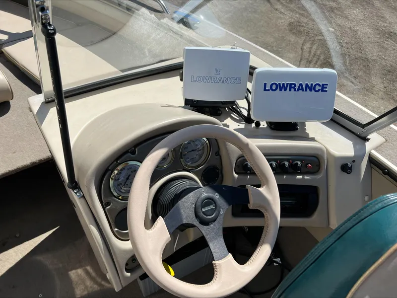Slide: The Image of 2001 Alumacraft Trophy 185 dashboard with Lowrance navigation system and steering wheel. - 15