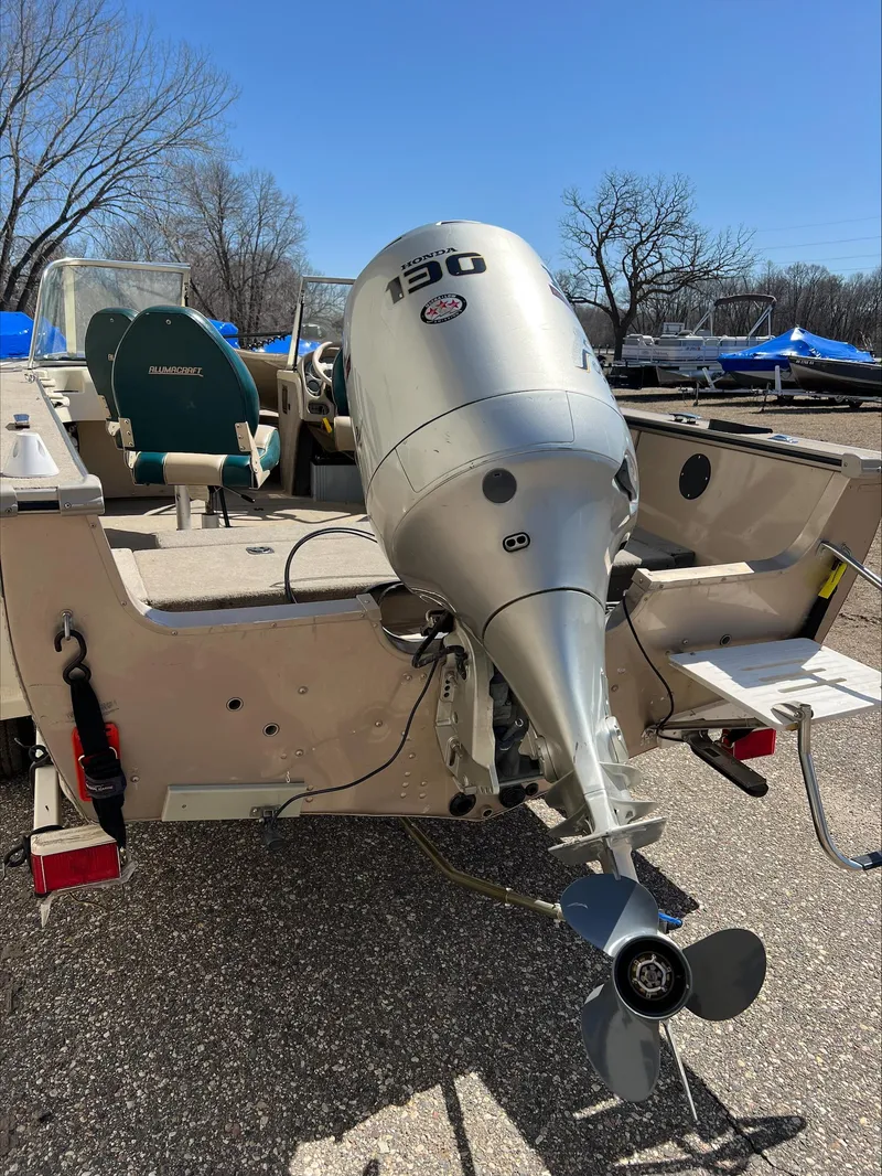 Slide: The Image of 2001 Alumacraft Trophy 185 boat with 130 HP outboard motor, parked outdoors. - 4