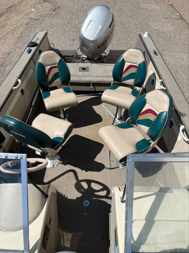 Slide: The Image of 2001 Alumacraft Trophy 185 boat interior with four seats and an outboard motor. - 5