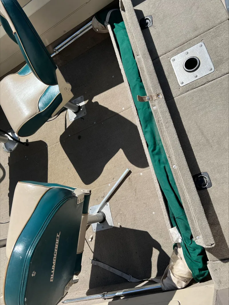 Slide: The Image of 2001 Alumacraft Trophy 185 boat interior with seating and storage compartments. - 6