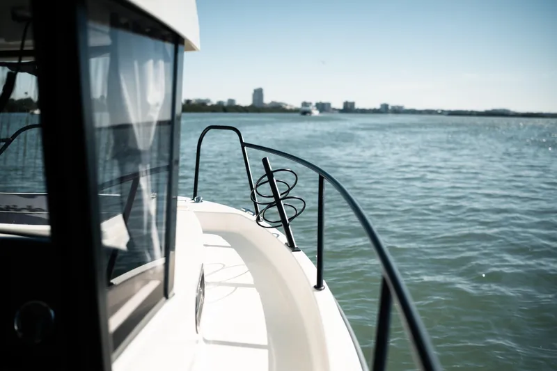 Slide: The Image of 2024 Bayliner Trophy T25 Pilothouse cruising on calm waters. - 23