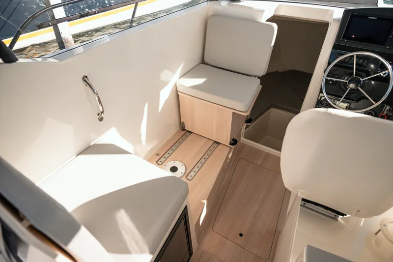 Slide: The Image of 2024 Bayliner Trophy T25 Pilothouse interior with seating and steering wheel. - 5