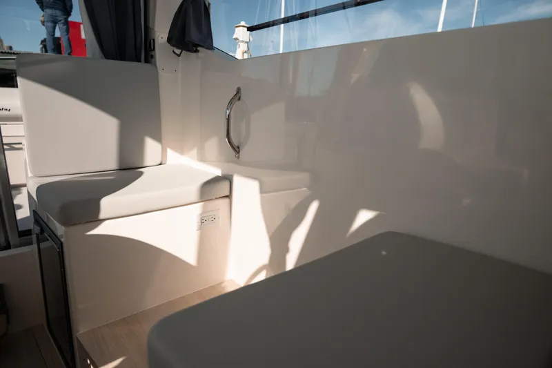 Slide: The Image of 2024 Bayliner Trophy T25 Pilothouse interior seating area with sunlight and shadows. - 6