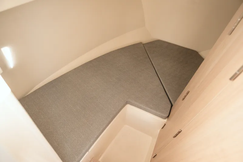 Slide: The Image of 2024 Bayliner Trophy T25 Pilothouse interior cabin with cushioned seating. - 7