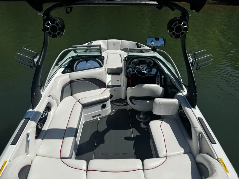Slide: The Image of 2012 Centurion Enzo SV230 boat interior with seating and steering wheel on water. - 12