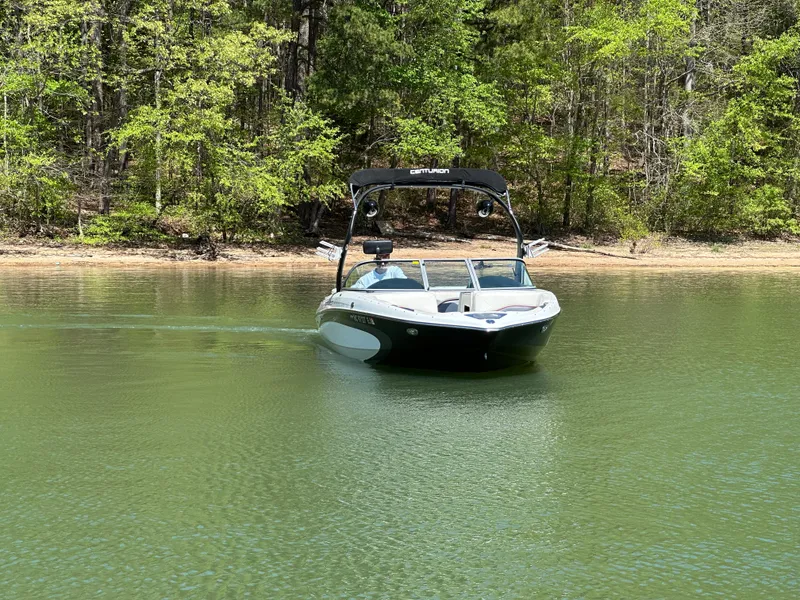 Slide: The Image of 2012 Centurion Enzo SV230 boat cruising on a serene lake with forested shoreline. - 3