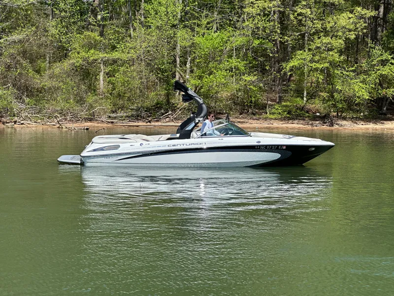 Slide: The Image of 2012 Centurion Enzo SV230 boat on a calm lake with forested background. - 7