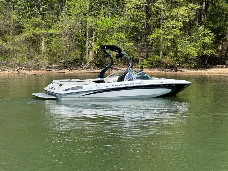 Slide: The Image of 2012 Centurion Enzo SV230 boat on a calm lake with forested background. - 8