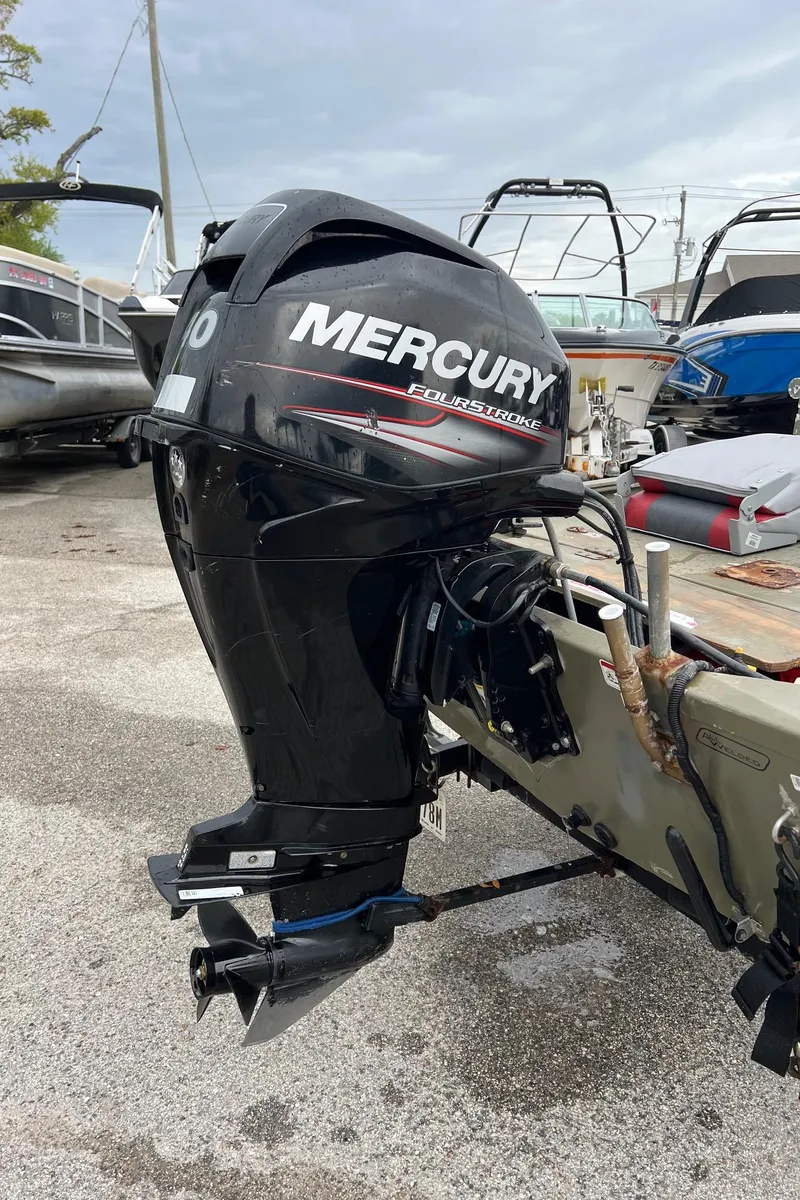 Slide: The Image of 2017 Tracker Grizzly 1648 boat with Mercury outboard motor in a marina setting. - 12
