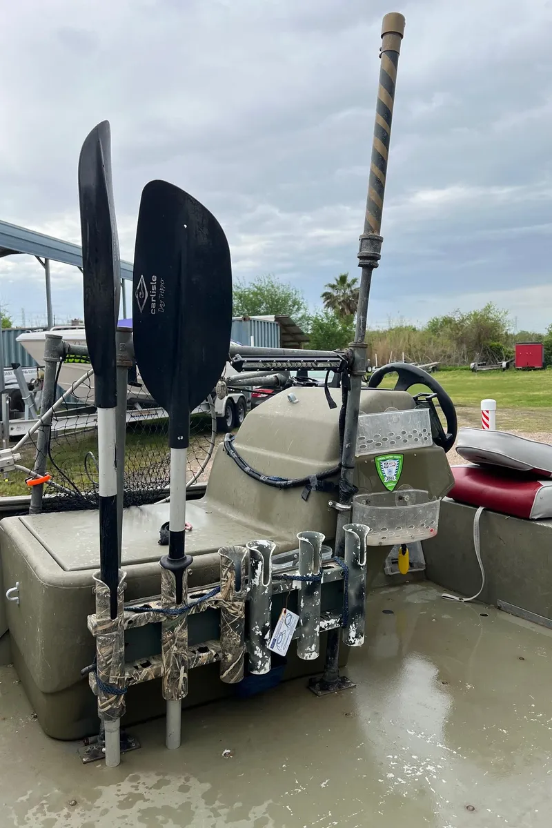 Slide: The Image of 2017 Tracker Grizzly 1648 boat with paddles and fishing rod holder. - 13