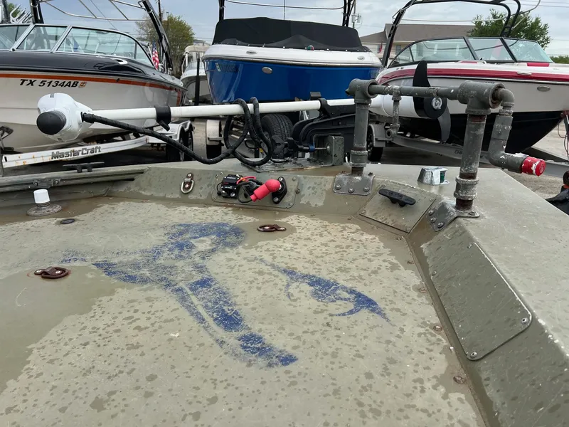Slide: The Image of 2017 Tracker Grizzly 1648 boat deck with fishing equipment, surrounded by other boats. - 3
