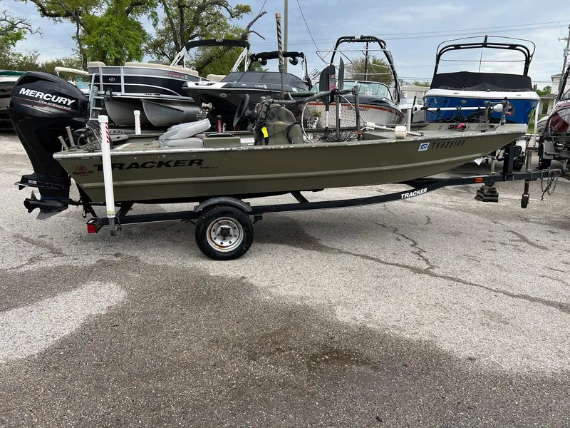 Slide: The Image of 2017 Tracker Grizzly 1648 boat on trailer, parked in a lot with other boats. - 4