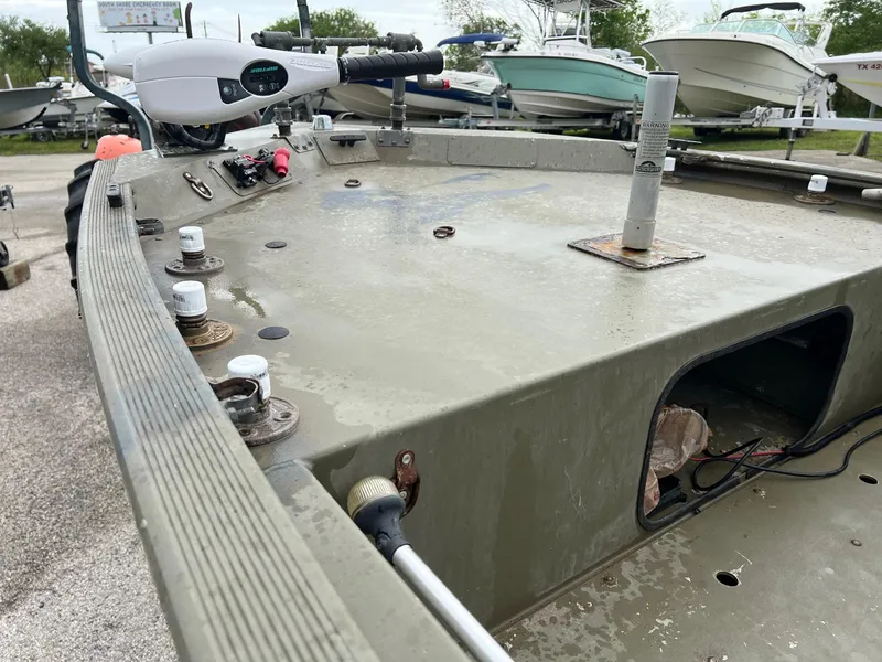 Slide: The Image of 2017 Tracker Grizzly 1648 boat deck with motor and storage compartments. - 7