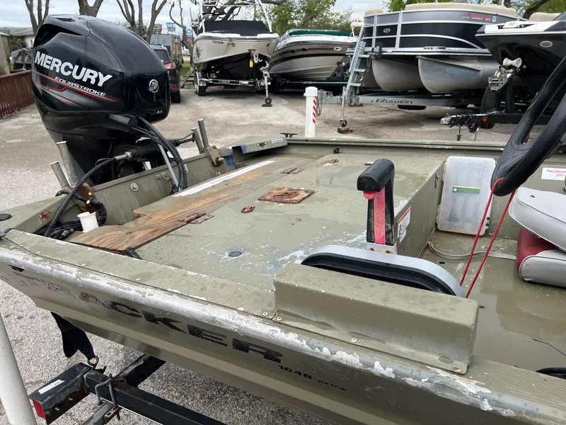Slide: The Image of 2017 Tracker Grizzly 1648 boat with Mercury outboard motor in a marina. - 9