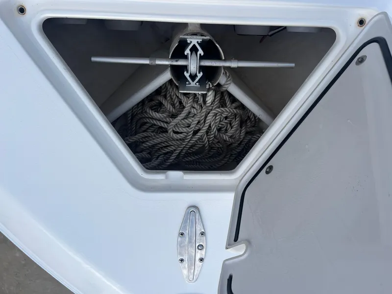 Slide: The Image of Anchor storage compartment on a 2016 Contender 35 ST boat, featuring coiled rope. - 14