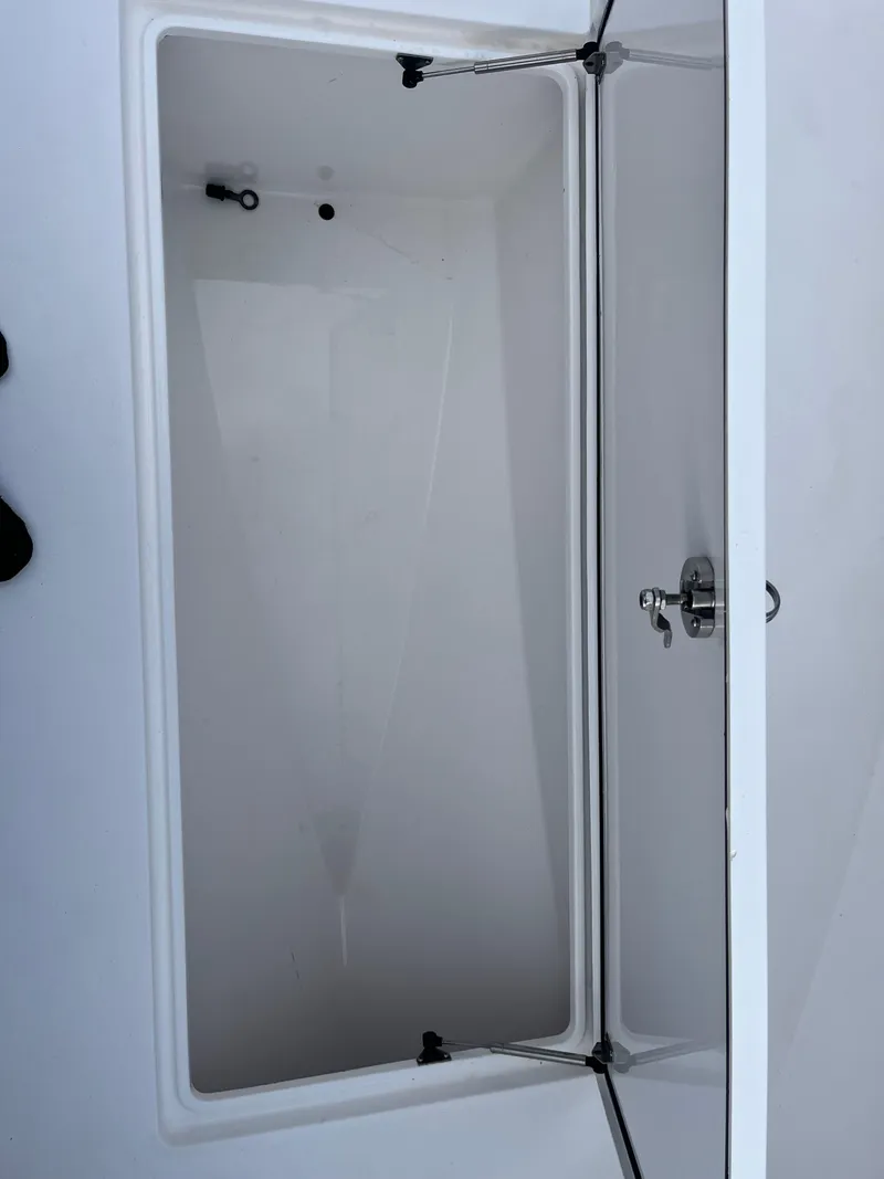 Slide: The Image of 2016 Contender 35 ST boat storage compartment, open and empty, showcasing interior space. - 15