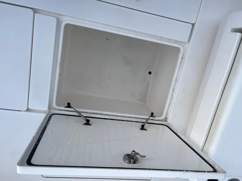 Slide: The Image of Open storage compartment on a 2016 Contender 35 ST boat. - 17