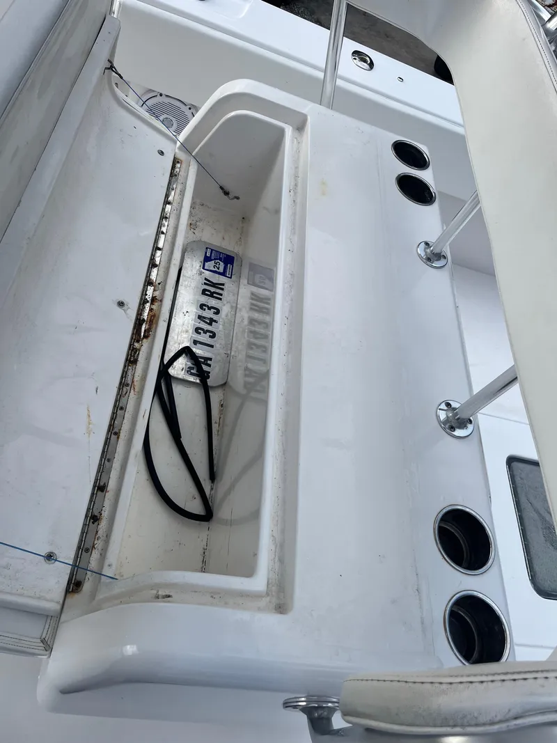 Slide: The Image of 2016 Contender 35 ST boat interior with storage compartment and cup holders. - 22
