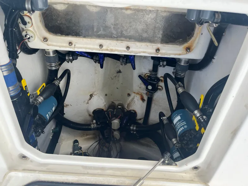 Slide: The Image of Engine compartment of a 2016 Contender 35 ST boat, showing hoses and mechanical components. - 4