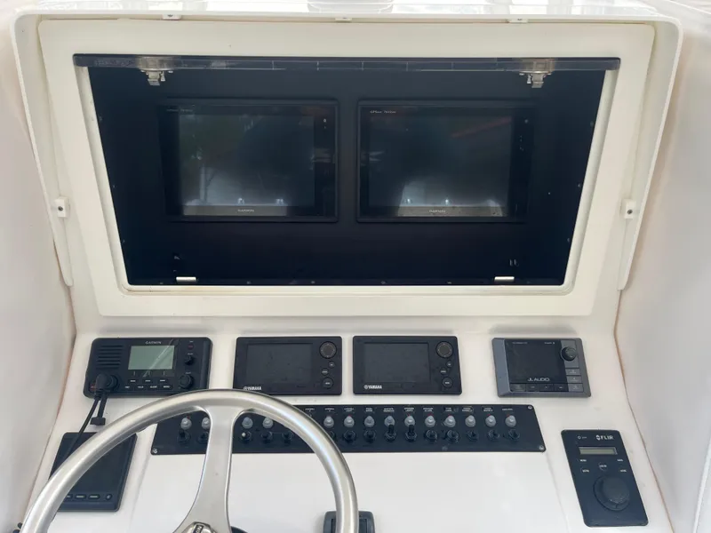 Slide: The Image of Control panel of a 2016 Contender 35 ST boat with dual screens and navigation equipment. - 6