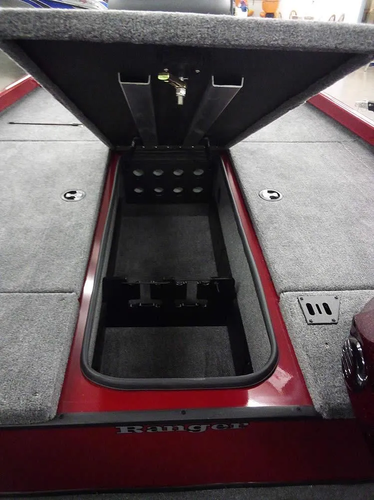 Slide: The Image of 2025 Ranger RT188C boat storage compartment with open lid, showcasing spacious interior and carpeted finish. - 10