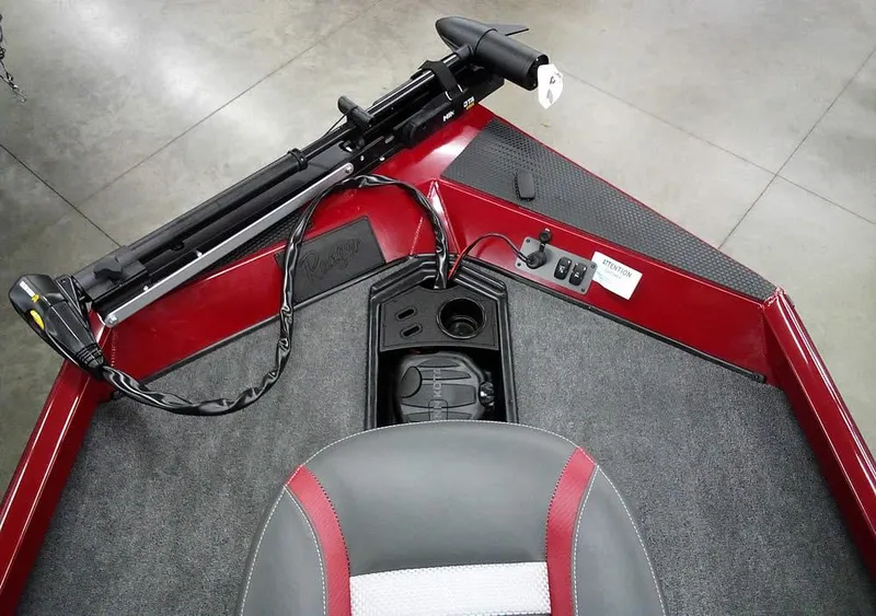 Slide: The Image of 2025 Ranger RT188C boat interior with red accents and trolling motor. - 13